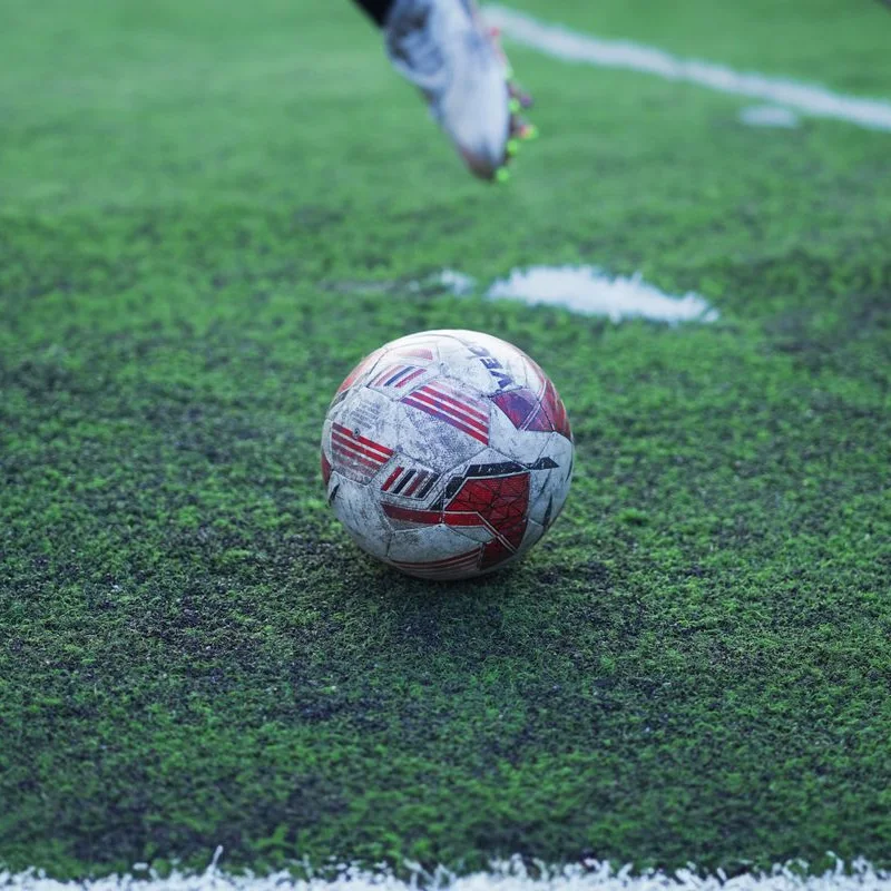 A football on the pitch, ready for kick-off